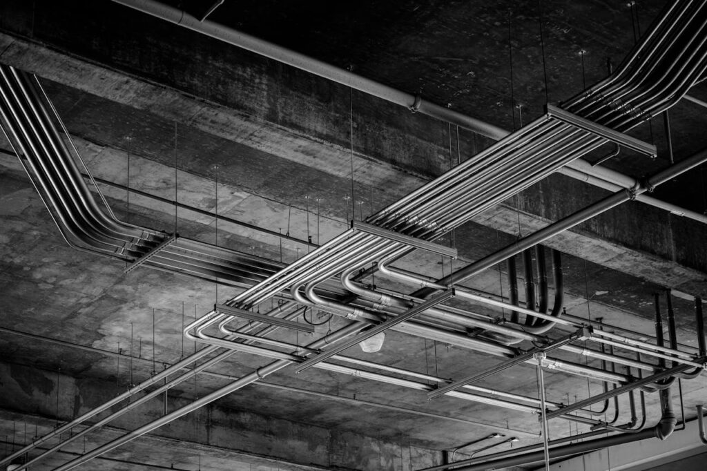 Black and white photo of industrial ceiling with metal pipelines in Boise, ID.