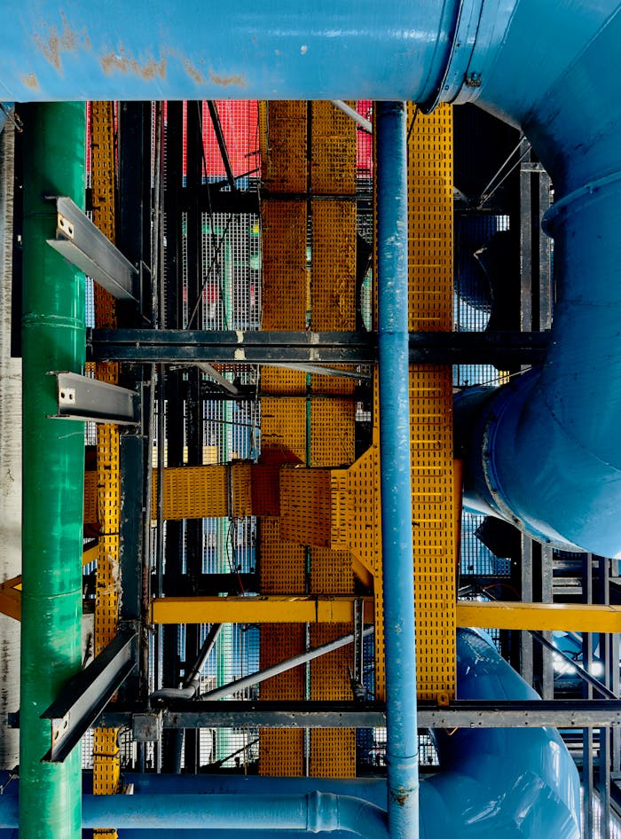 Vivid industrial scene with colorful pipes and metal structures.